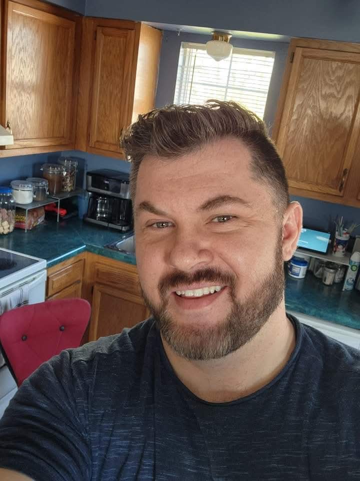 Portrait of Leon L Smooth smiling in his kitchen